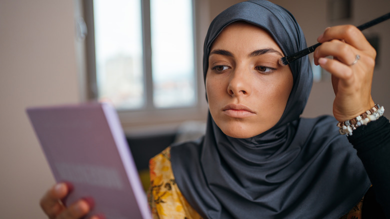 Woman applying eyeshadow