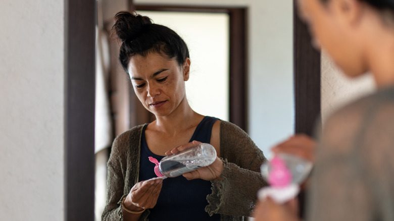 Woman using micellar water