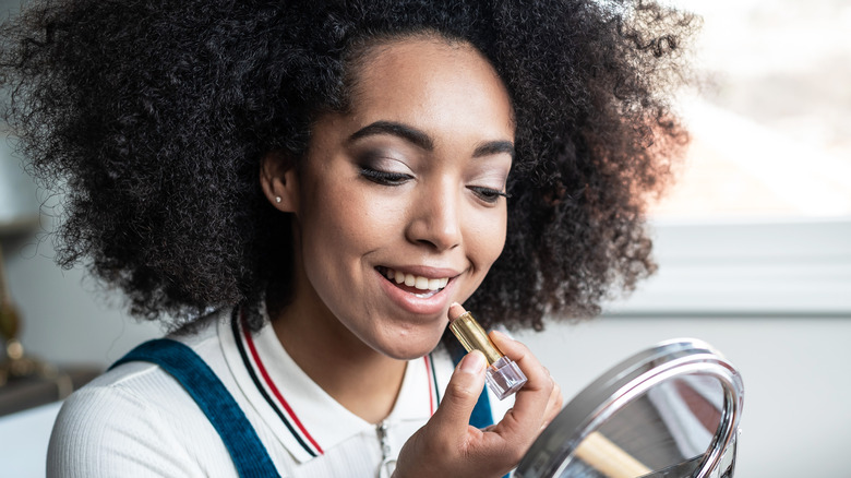 woman applying lipstick