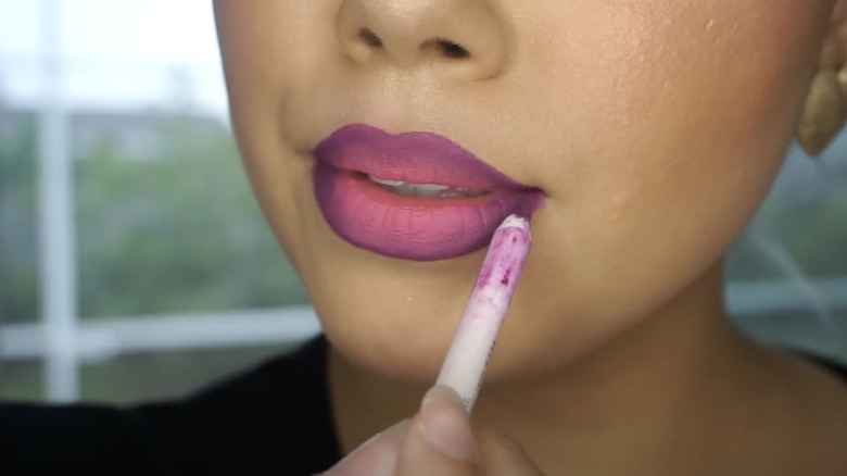 woman applying lip liner