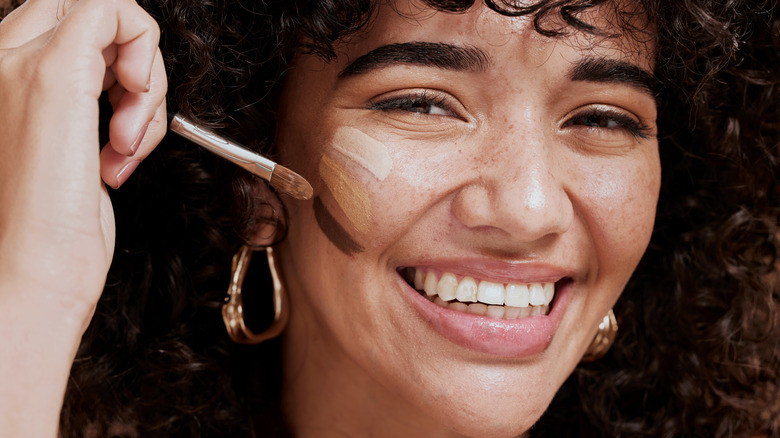 Woman testing makeup foundations