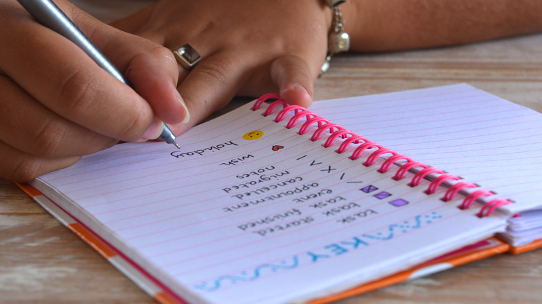 woman writing in a bullet journal