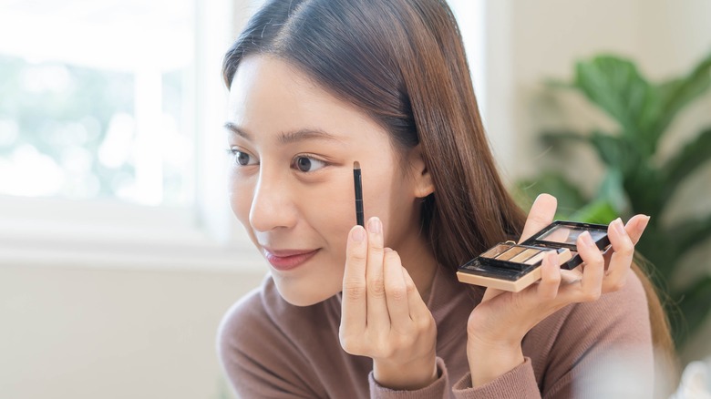 Woman doing her makeup