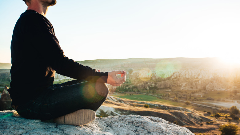 Man sitting outside meditating