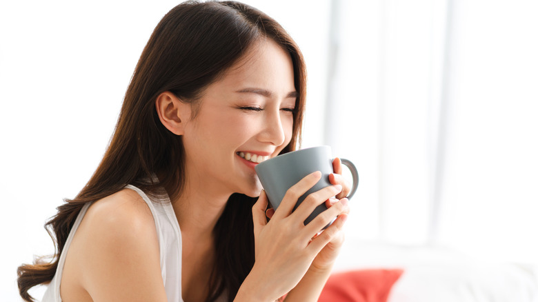 woman drinking coffee and smiling