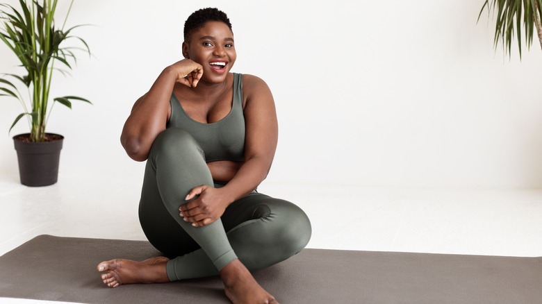 woman in yoga clothes smiling