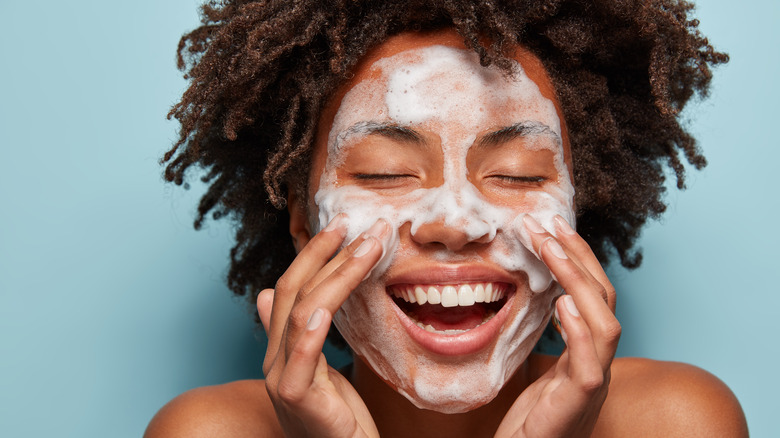 happy woman washing face