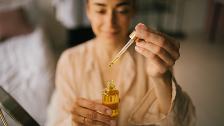 Woman using face oil