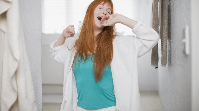 Woman standing and stretching at home