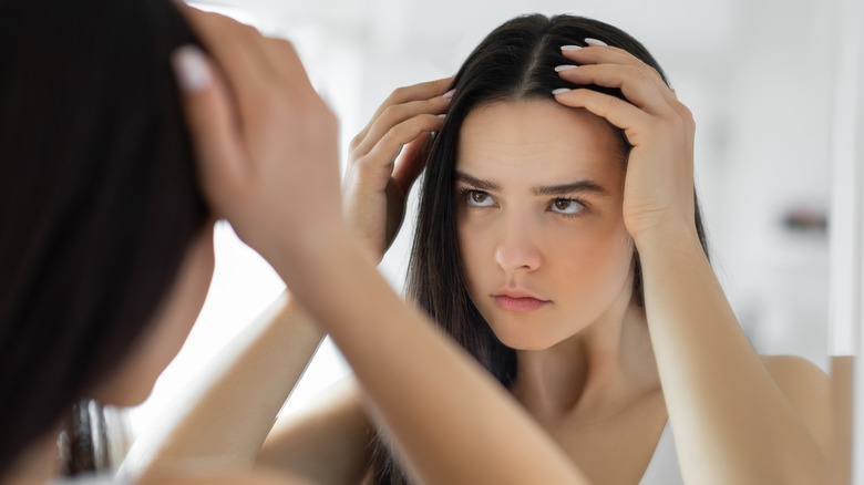 woman noticing thinning hair