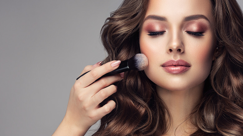 woman having makeup applied