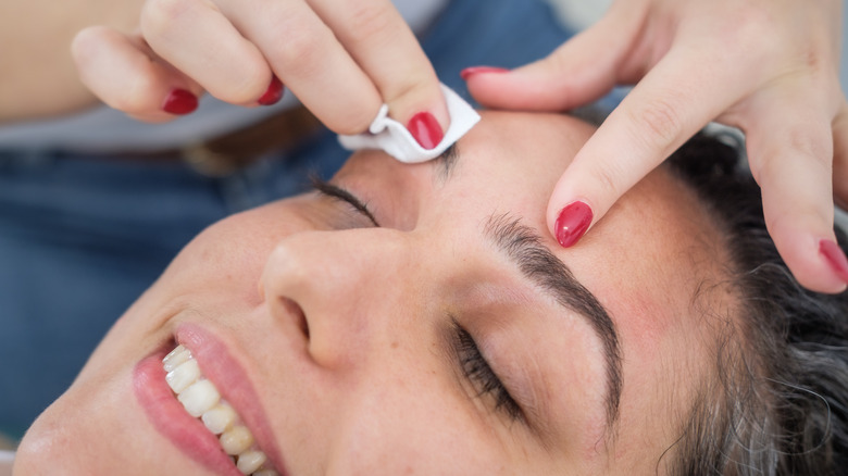 applying soothing ointment to red skin