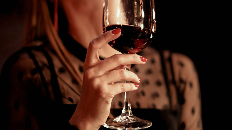 Woman holds wine glass