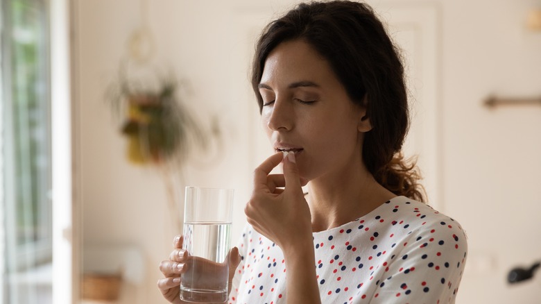 Woman takes pill