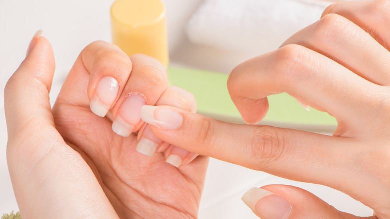 woman applying cuticle oil