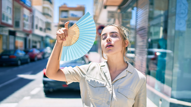 woman fanning herself 