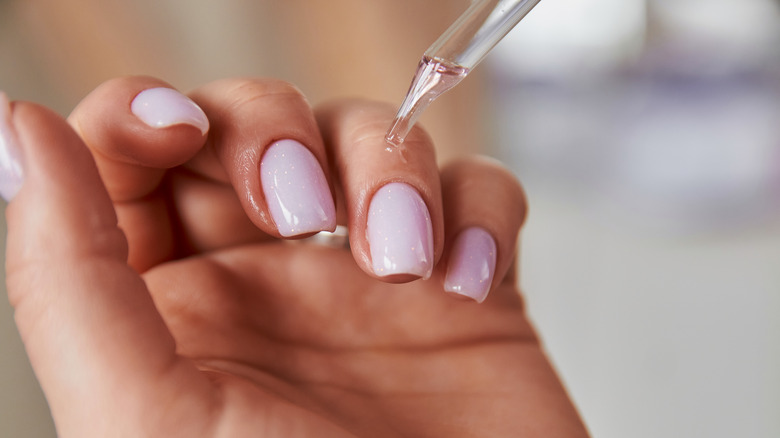 applying oil to nail cuticles