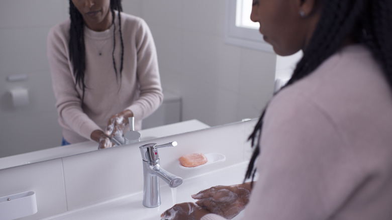 Woman washes hands