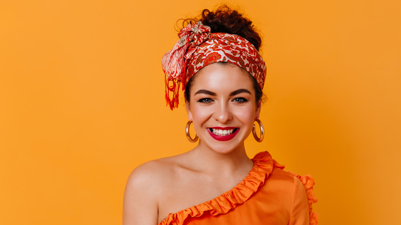 woman with curly hair in scarf