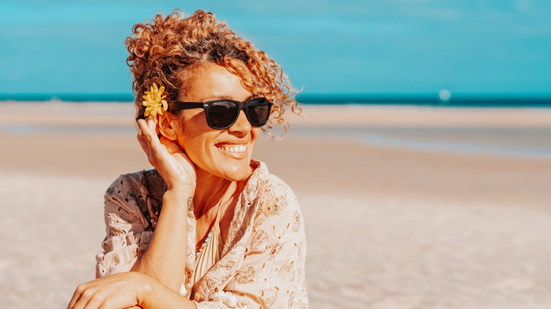 woman with curly hair on beach