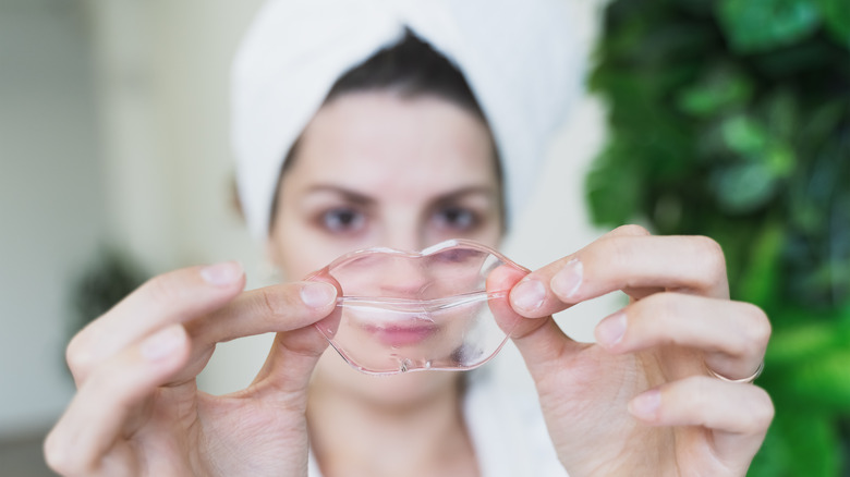 Woman holding collagen lip mask