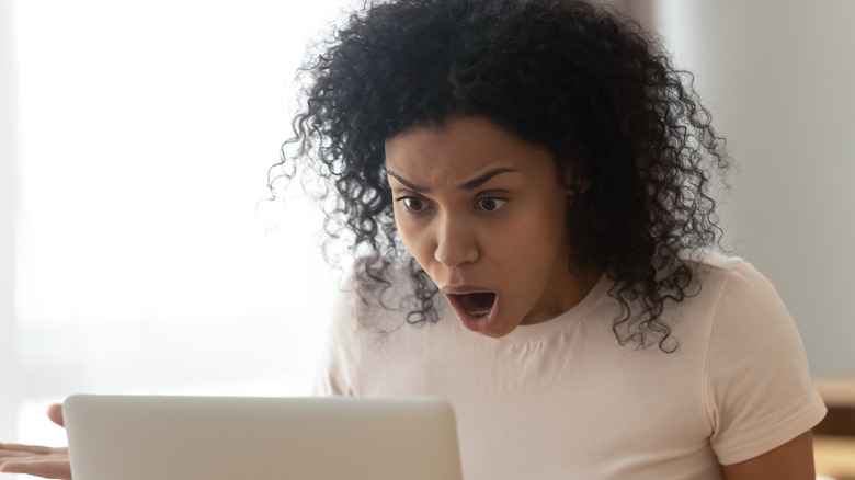 shocked woman looking at computer