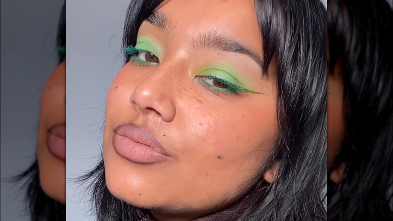 A woman with green makeup