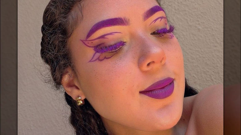 A woman with purple makeup