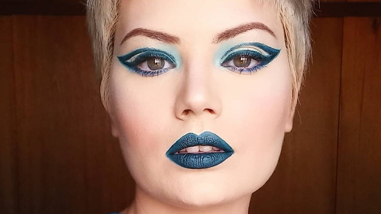A woman with blue makeup
