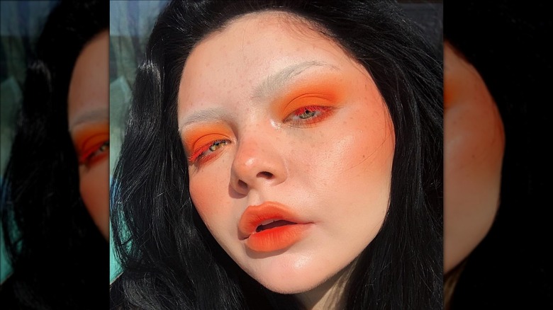 A woman with orange makeup