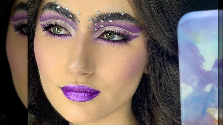 A woman with purple makeup