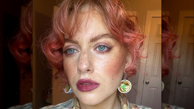 A woman with dark pink makeup