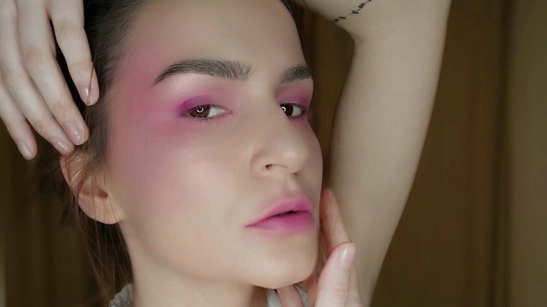 A woman with pink makeup