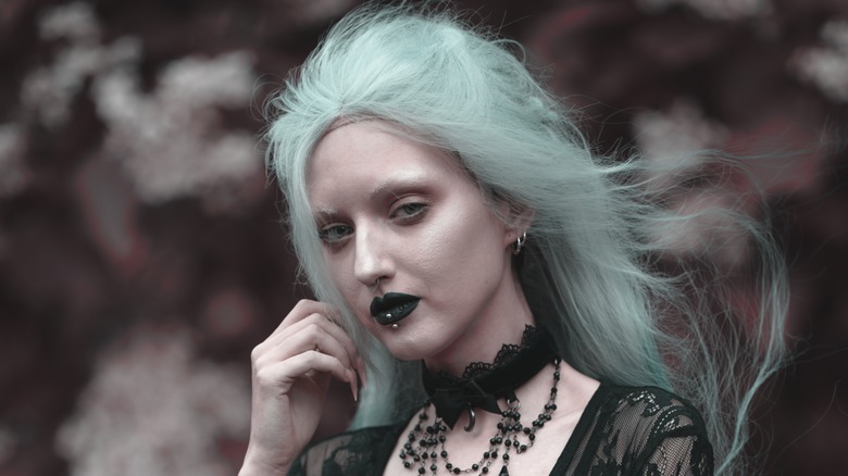 person with dark teal lipstick