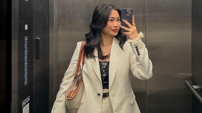 woman with styled wavy hair wearing two-piece suit 