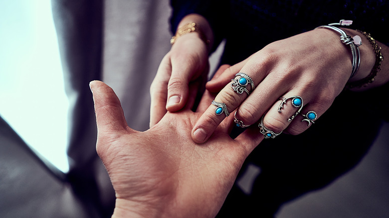 jeweled hand person touching palm