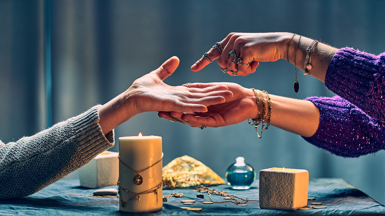 person pointing at palm over table