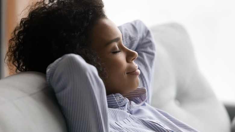 woman smiling while napping