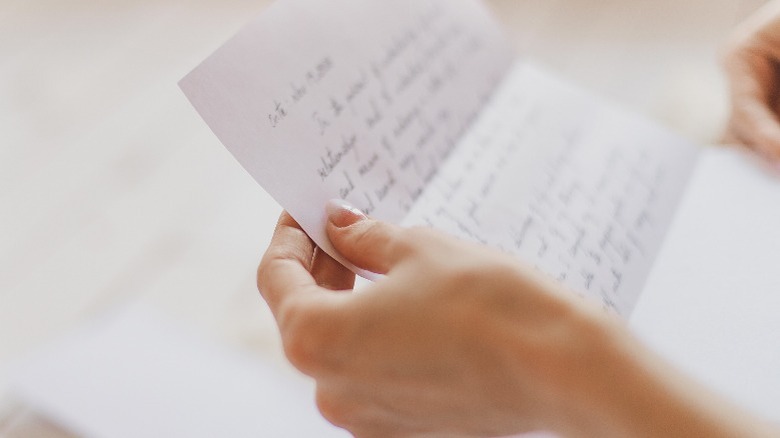 Person holding handwritten letter