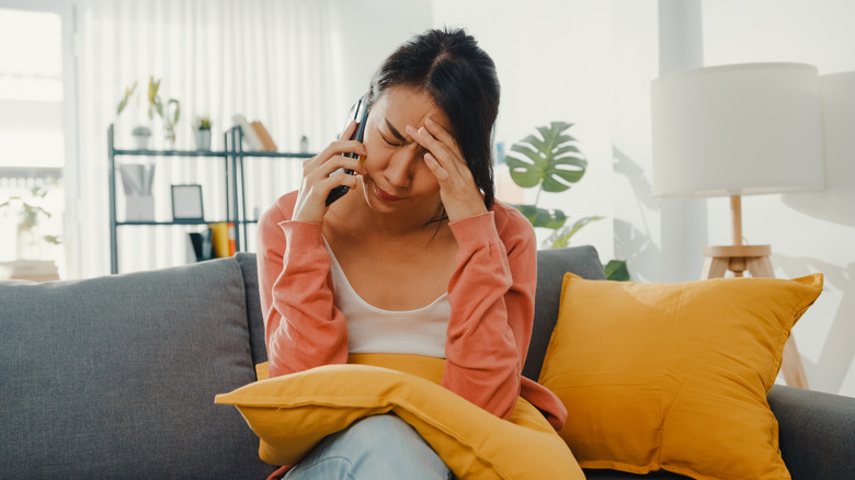 Woman appears stressed during phone call