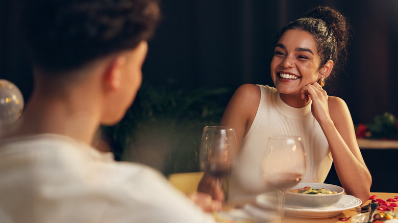 A happy couple sharing red wine on a date