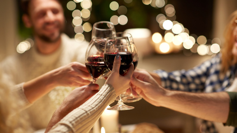 Group clinking red wine glasses