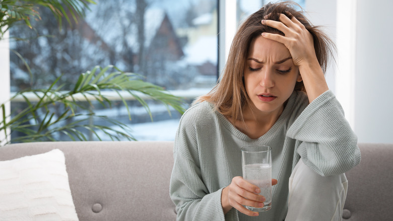 Woman distressed with water glass