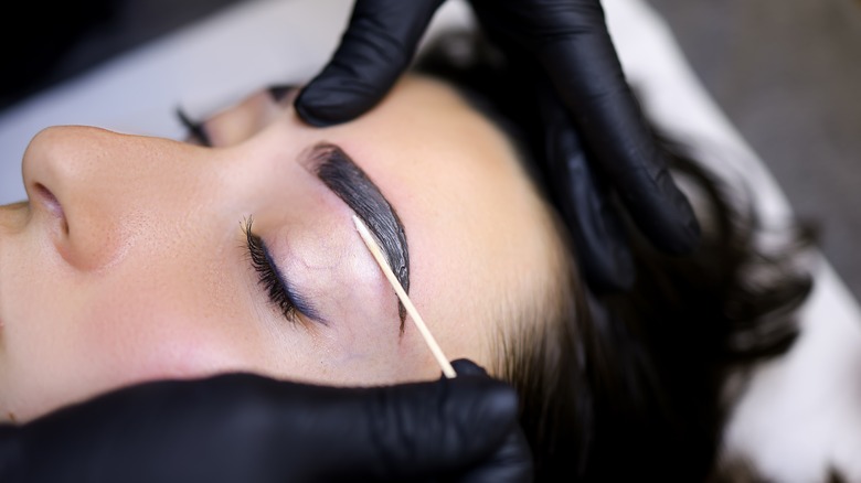 Woman getting eyebrows laminated