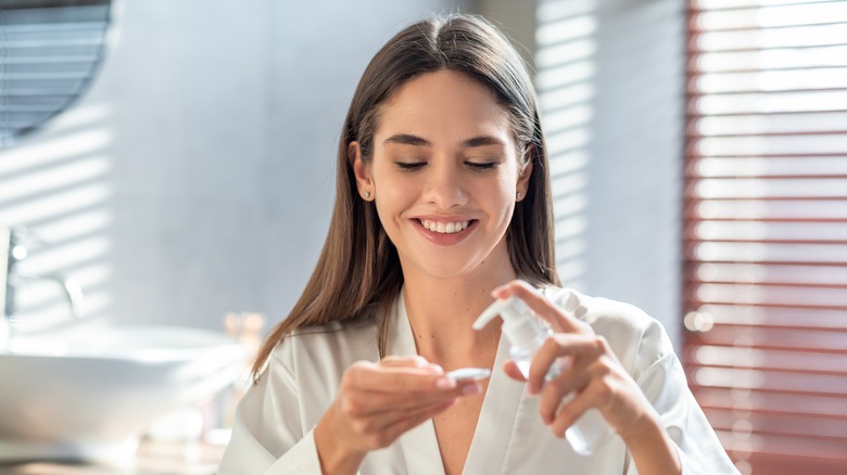 woman applying glycolic acid toner