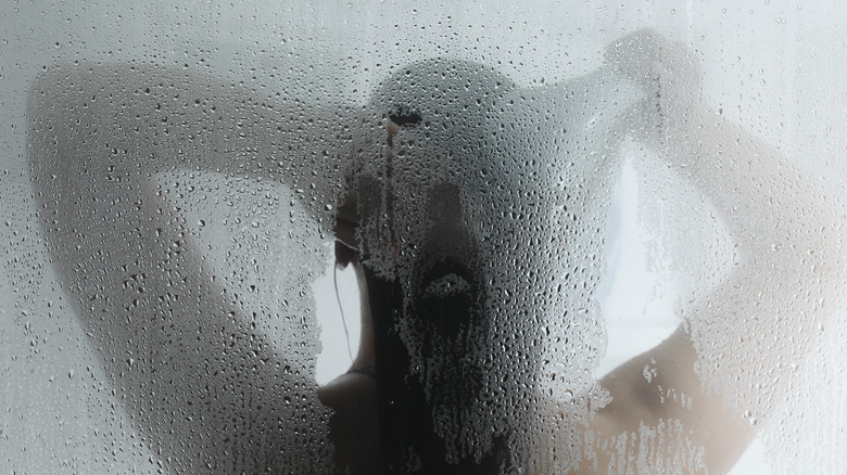 woman taking hot steam shower