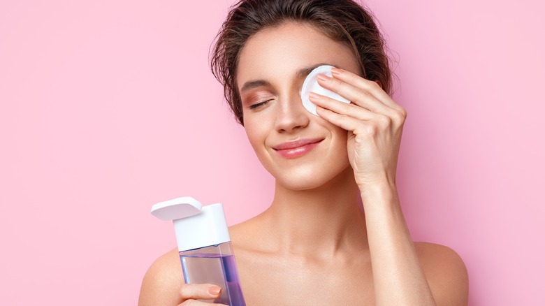 Woman removing eye makeup 