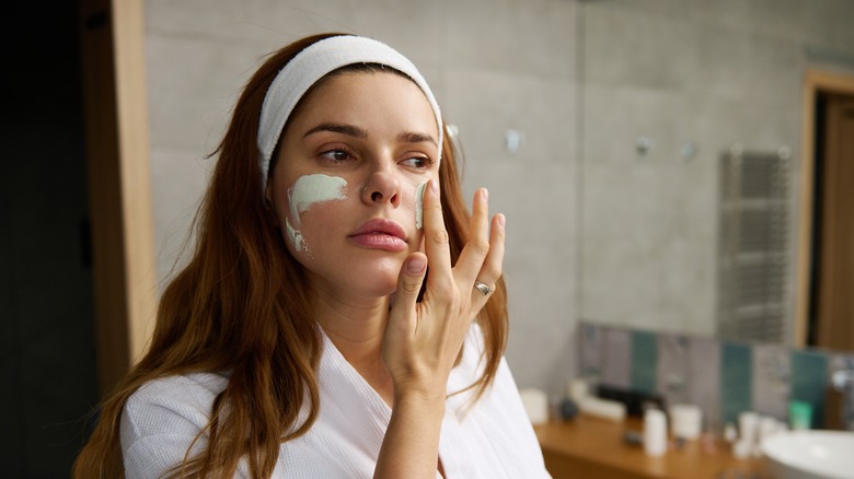 woman applying skincare product