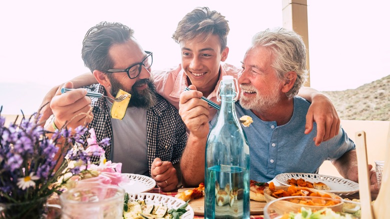 Three men eating meal together