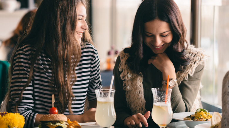 two friends talking over meal